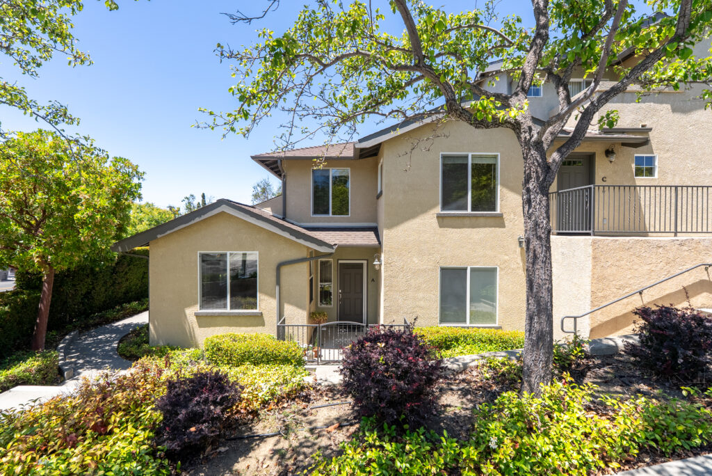 Front exterior view of the unit with private entrance and mature landscaping