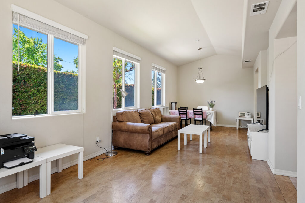 Bright living and dining area with large windows and natural light