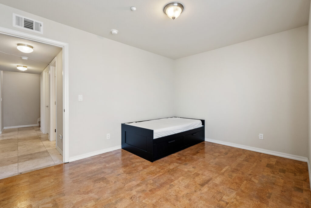 Second bedroom with tile floors and built-in storage drawers
